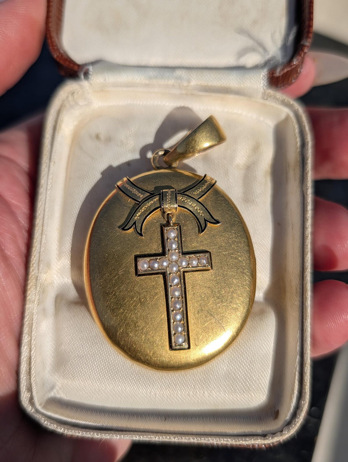 Pearl cross and black enamel bow detail